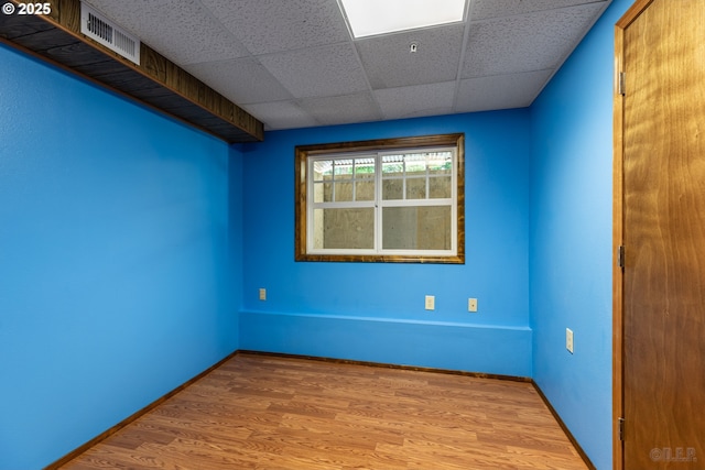 25363 Wonderly Rd, Rainier, OR 97048 - empty room with a paneled ceiling, wood finished floors, and baseboards