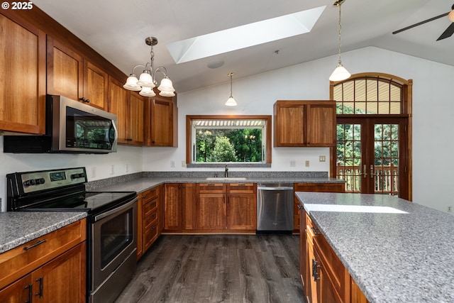 25363 Wonderly Rd, Rainier, OR 97048 - kitchen featuring appliances with stainless steel finishes, a skylight, vaulted ceiling, dark wood-style floors, and a sink