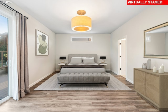 bedroom with wood finished floors and baseboards
