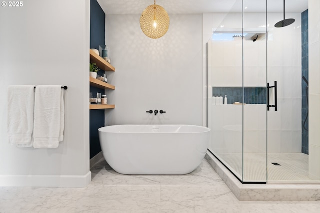 full bathroom with a stall shower, a soaking tub, marble finish floors, and baseboards