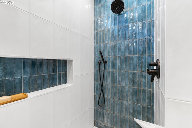 bathroom with a tile shower
