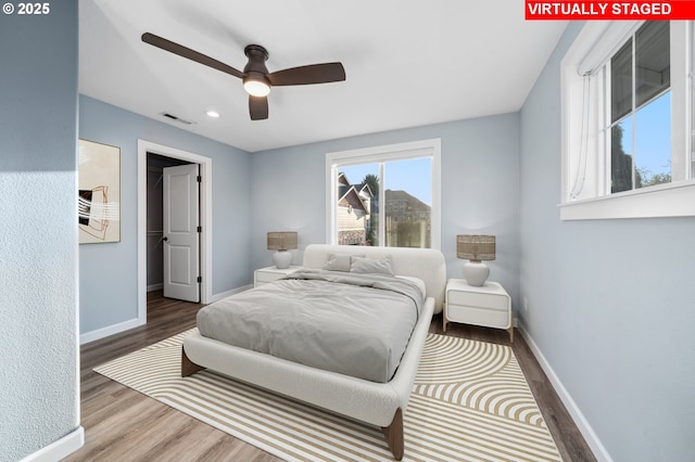 bedroom featuring wood finished floors, baseboards, recessed lighting, and ceiling fan