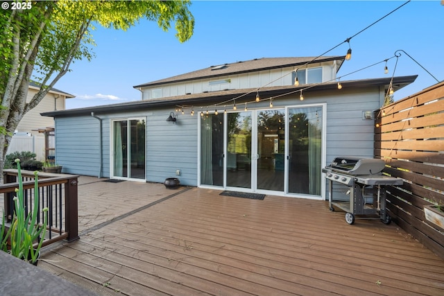 deck featuring a grill and fence