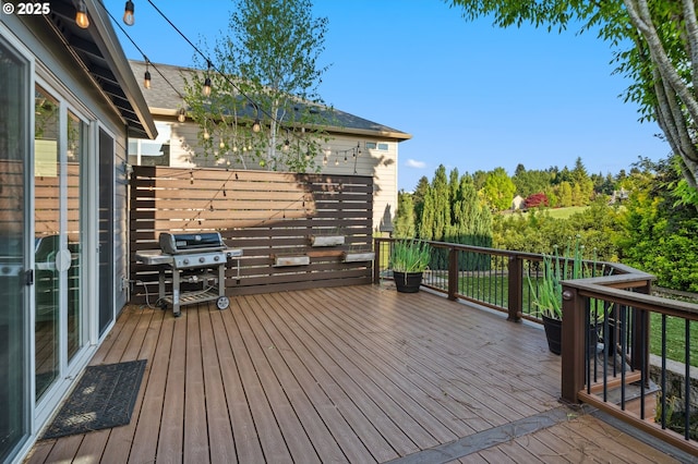 wooden deck featuring area for grilling