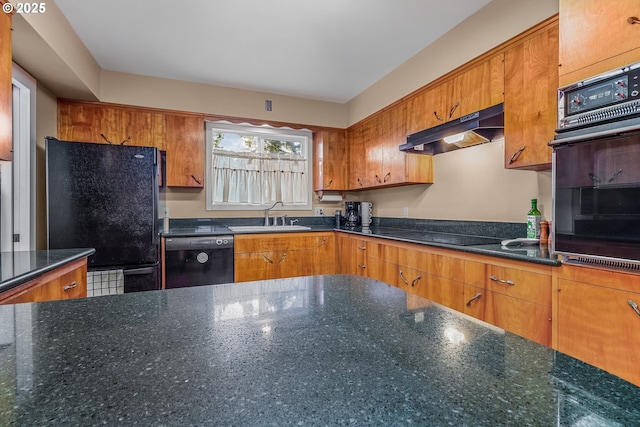 kitchen featuring black appliances, under cabinet range hood, brown cabinetry, and a sink