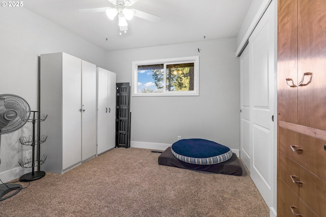 carpeted bedroom featuring a ceiling fan, baseboards, and a closet