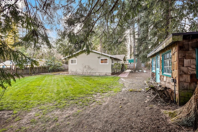 view of yard featuring an outbuilding and a fenced backyard