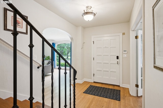 7150 SE 27th Ave, Portland, OR 97202 - foyer with arched walkways, light wood-style flooring, and stairway