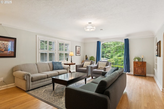 7150 SE 27th Ave, Portland, OR 97202 - living area with light wood-style floors, a textured ceiling, and crown molding