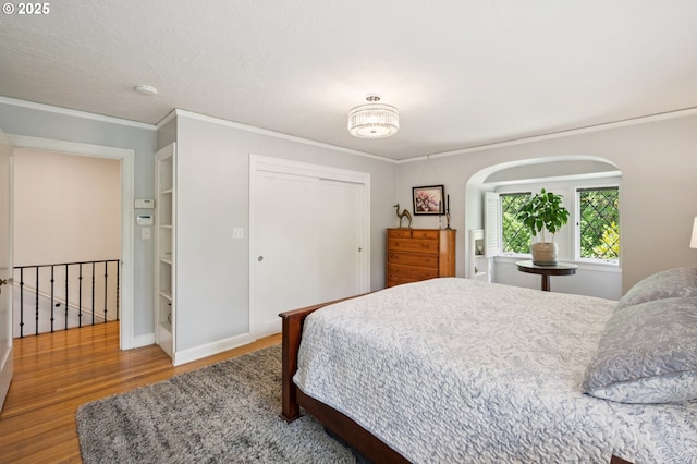 7150 SE 27th Ave, Portland, OR 97202 - bedroom with wood finished floors, ornamental molding, and a closet