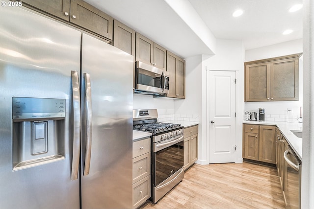 kitchen with stainless steel appliances, light wood-type flooring, light countertops, and recessed lighting