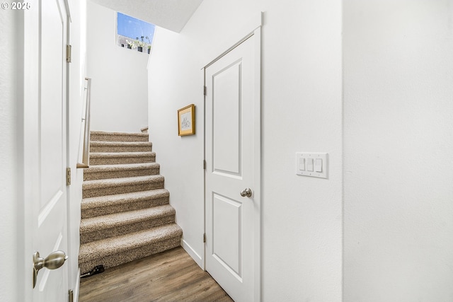 stairs with wood finished floors