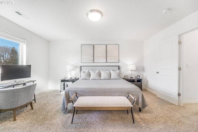 bedroom with carpet, visible vents, and baseboards