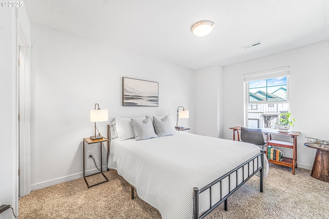 bedroom featuring light carpet, baseboards, and visible vents