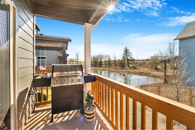 balcony featuring a water view and a grill