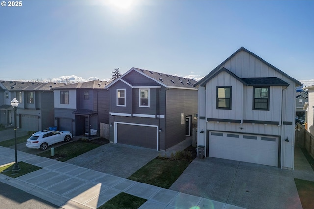 view of front of property featuring a garage, driveway, board and batten siding, and a residential view