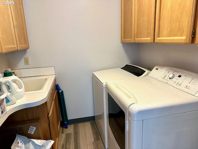 4120 NE 52nd St, Vancouver, WA 98661 - laundry area featuring cabinet space, washer and clothes dryer, and wood finished floors