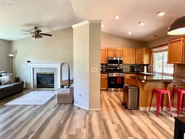 4120 NE 52nd St, Vancouver, WA 98661 - kitchen with appliances with stainless steel finishes, open floor plan, light wood-style floors, ceiling fan, and lofted ceiling