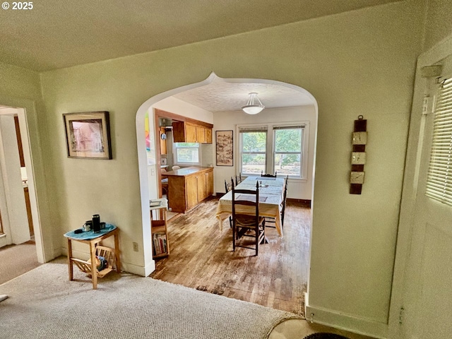 991 Polk St, Eugene, OR 97402 - dining room with arched walkways and light wood-style floors