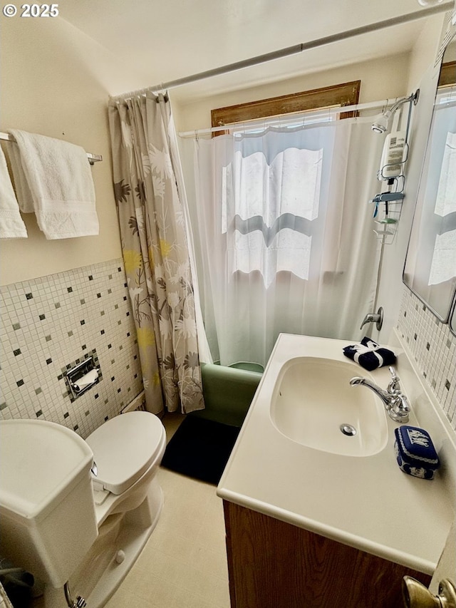 991 Polk St, Eugene, OR 97402 - full bathroom featuring vanity, shower / bath combination with curtain, tile walls, and a wainscoted wall