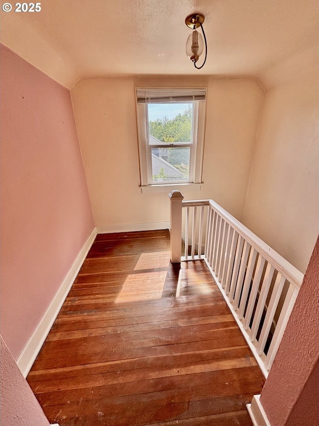 991 Polk St, Eugene, OR 97402 - bonus room featuring wood-type flooring, vaulted ceiling, and a textured ceiling
