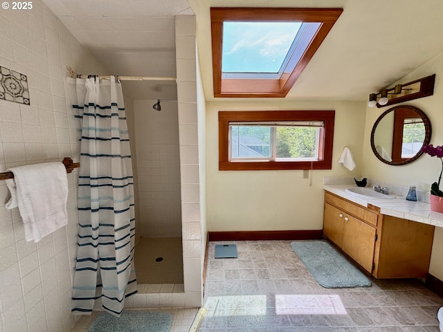 991 Polk St, Eugene, OR 97402 - full bathroom featuring a skylight, vanity, a tile shower, lofted ceiling, and tile patterned flooring