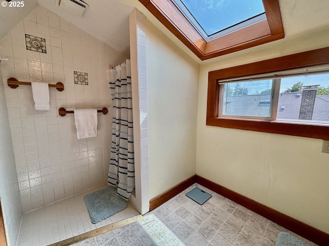 991 Polk St, Eugene, OR 97402 - bathroom featuring a skylight, a tile shower, and vaulted ceiling