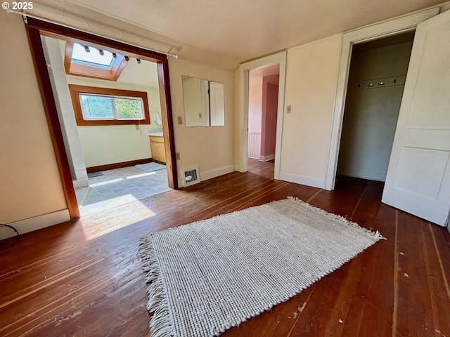 991 Polk St, Eugene, OR 97402 - unfurnished bedroom featuring a skylight, wood-type flooring, a closet, and ensuite bathroom