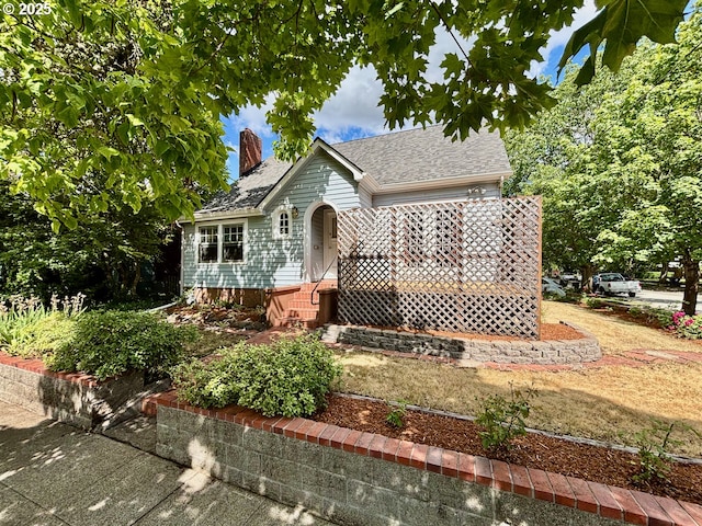991 Polk St, Eugene, OR 97402 - view of front of house with a chimney and roof with shingles