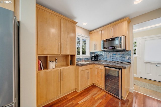 17460 Old Pacific Hwy, Rockaway Beach, OR 97136 - kitchen featuring wine cooler, appliances with stainless steel finishes, a sink, light brown cabinetry, and recessed lighting