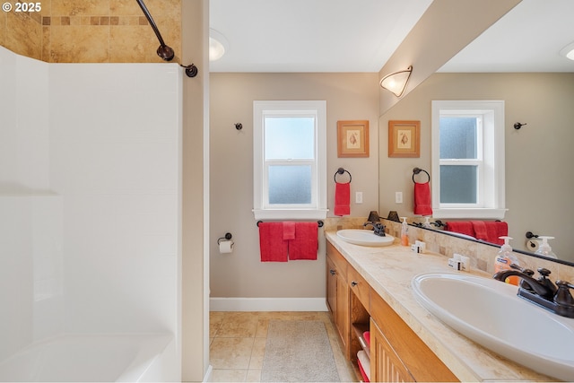 17460 Old Pacific Hwy, Rockaway Beach, OR 97136 - bathroom featuring double vanity, tile patterned flooring, shower / tub combination, and baseboards