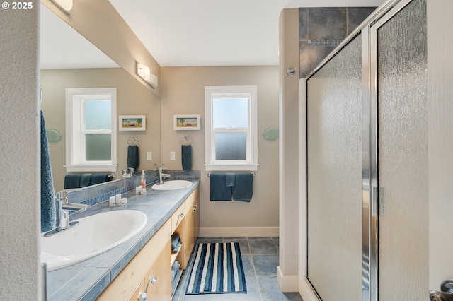 17460 Old Pacific Hwy, Rockaway Beach, OR 97136 - full bath with baseboards, double vanity, a stall shower, and tile patterned floors