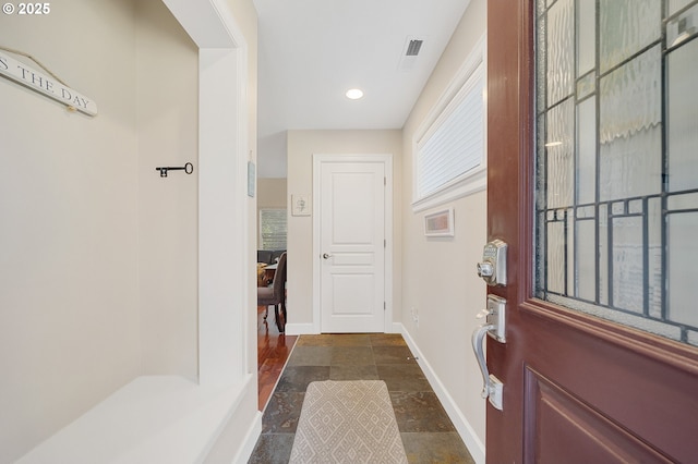 17460 Old Pacific Hwy, Rockaway Beach, OR 97136 - foyer entrance featuring baseboards, dark stone finish floors, and recessed lighting