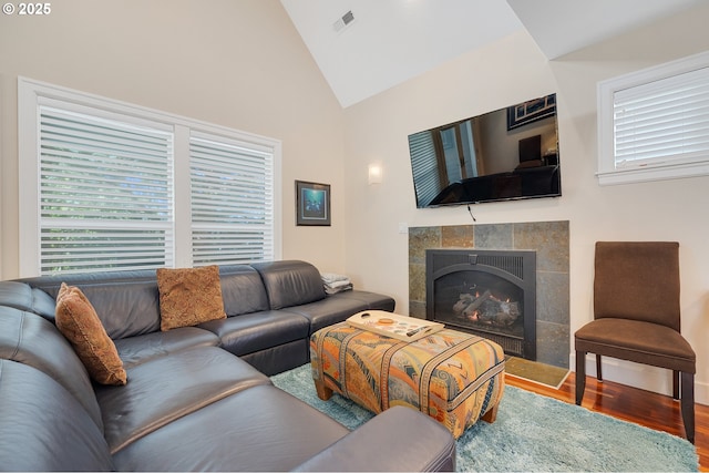 17460 Old Pacific Hwy, Rockaway Beach, OR 97136 - living area featuring lofted ceiling, wood finished floors, and a tiled fireplace