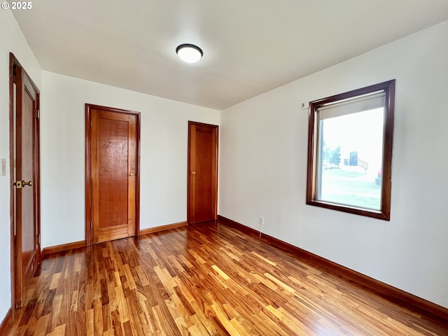 610 NE N St, Hermiston, OR 97838 - unfurnished bedroom with light wood-style flooring and baseboards