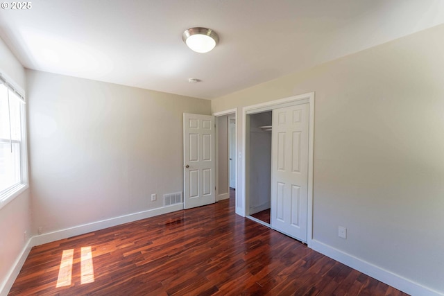 3826 SE 50th Ave, Portland, OR 97206 - unfurnished bedroom featuring multiple windows, dark wood finished floors, and a closet