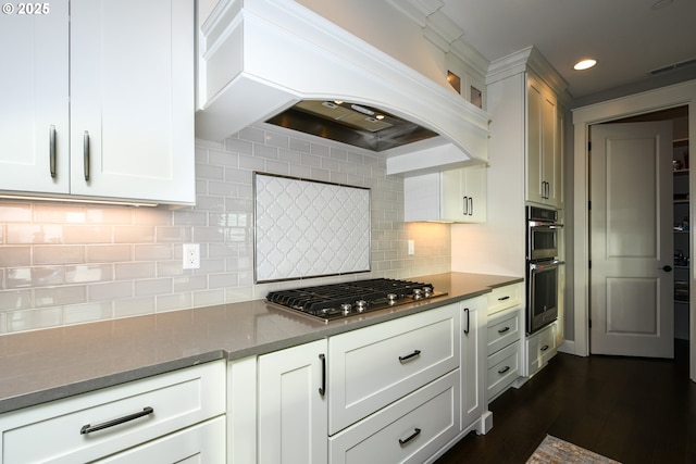 1936 NW Klickitat St, Camas, WA 98607 - kitchen featuring white cabinetry, tasteful backsplash, premium range hood, dark stone counters, and appliances with stainless steel finishes