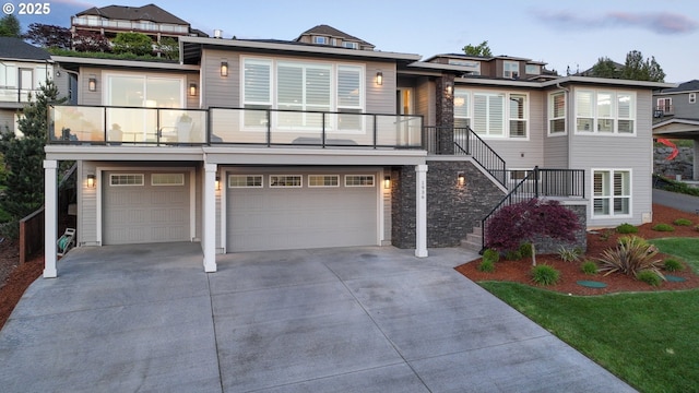 1936 NW Klickitat St, Camas, WA 98607 - view of front of home featuring stone siding, concrete driveway, stairway, and an attached garage