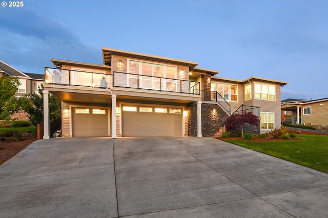 1936 NW Klickitat St, Camas, WA 98607 - view of front facade with stairway, stone siding, a balcony, driveway, and a garage
