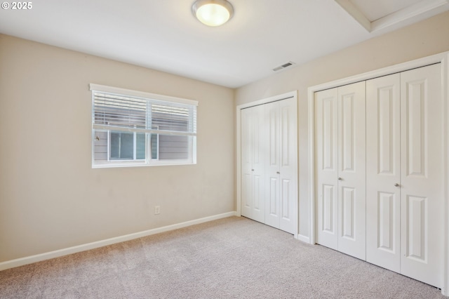 6195 NE Sherborne St, Hillsboro, OR 97124 - unfurnished bedroom with two closets, carpet flooring, and attic access