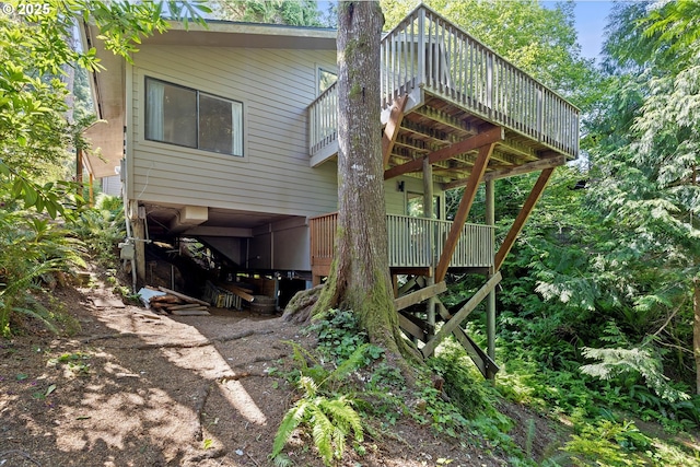 563 Fairway Dr, Gleneden Beach, OR 97388 - rear view of house featuring a wooden deck and a chimney