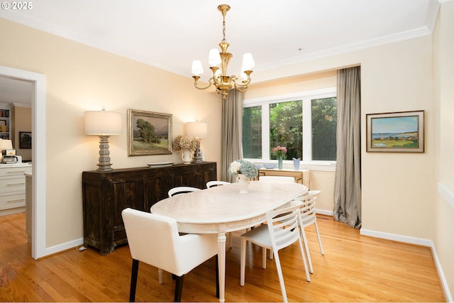 dining area with a chandelier, crown molding, light wood-style flooring, and baseboards