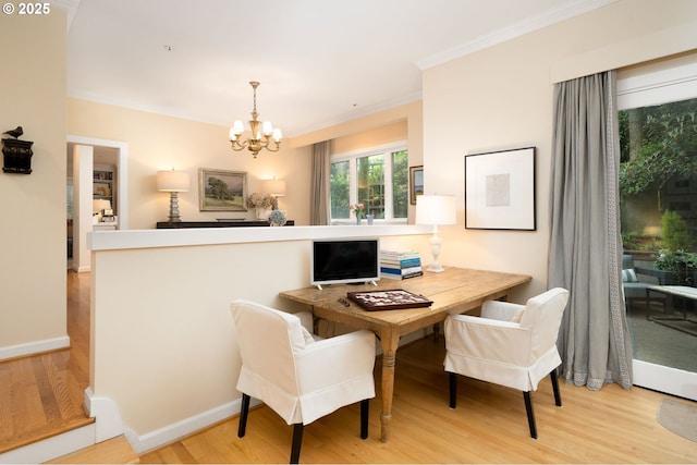 dining room featuring a chandelier, ornamental molding, wood finished floors, a desk, and baseboards