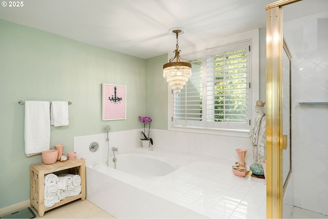 bathroom featuring a chandelier, a bath, a shower stall, and tile patterned flooring