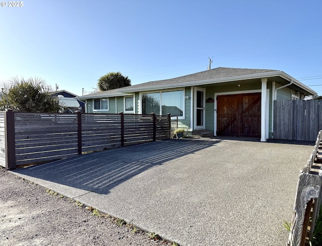 1206 Iris St, Brookings, OR 97415 - ranch-style house featuring a garage, a shingled roof, and fence