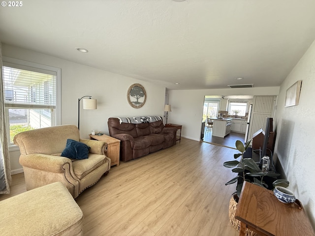 1206 Iris St, Brookings, OR 97415 - living room featuring baseboards, visible vents, recessed lighting, and light wood-style floors