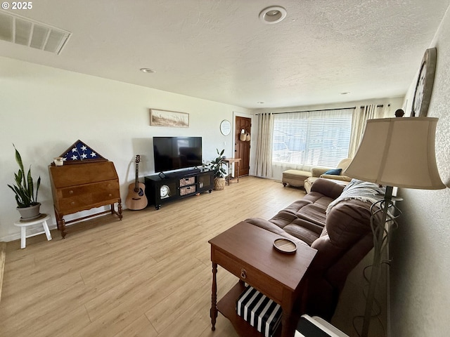 1206 Iris St, Brookings, OR 97415 - living area featuring a textured ceiling, visible vents, and light wood-type flooring