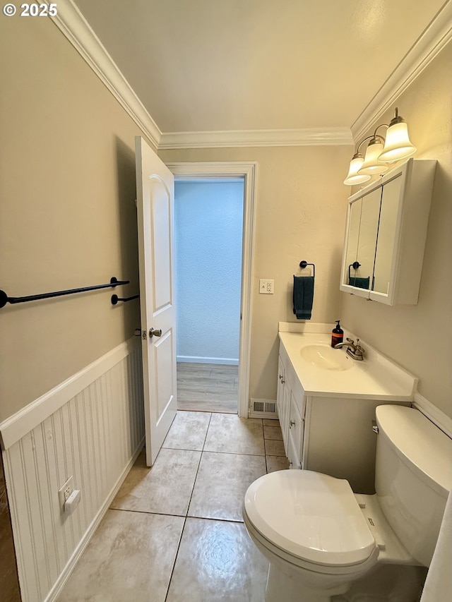 1206 Iris St, Brookings, OR 97415 - bathroom featuring toilet, vanity, crown molding, and tile patterned floors