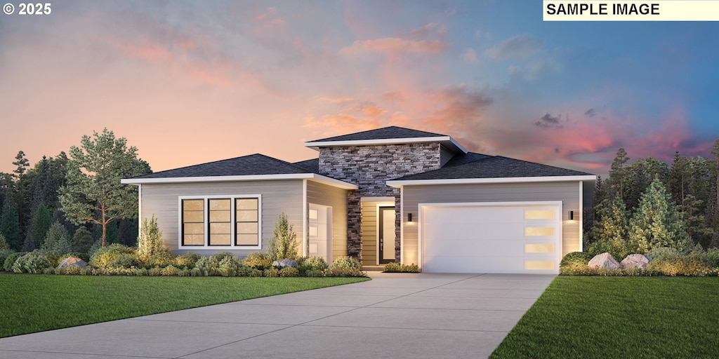 view of front of property featuring a garage and a yard