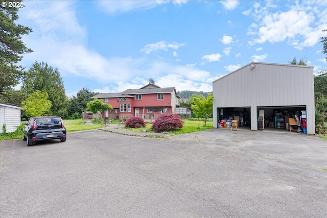 view of front facade with a garage and an outbuilding
